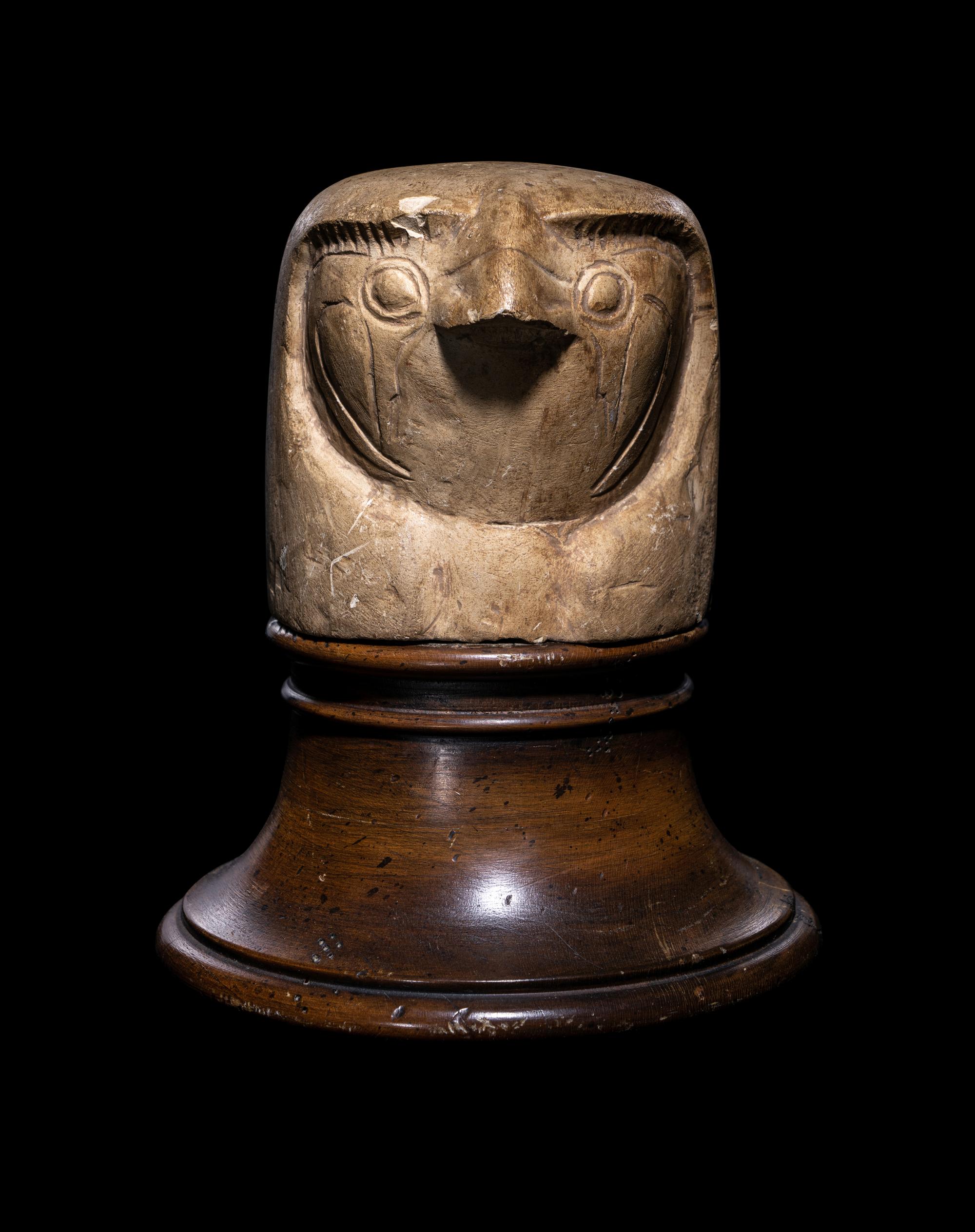 An Egyptian Limestone Canopic Jar Lid in the Form of Qebhsenuef
