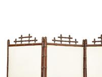A Victorian Carved Mahogany and Parcel Gilt Faux-Bamboo Upholstered Four-Panel Screen