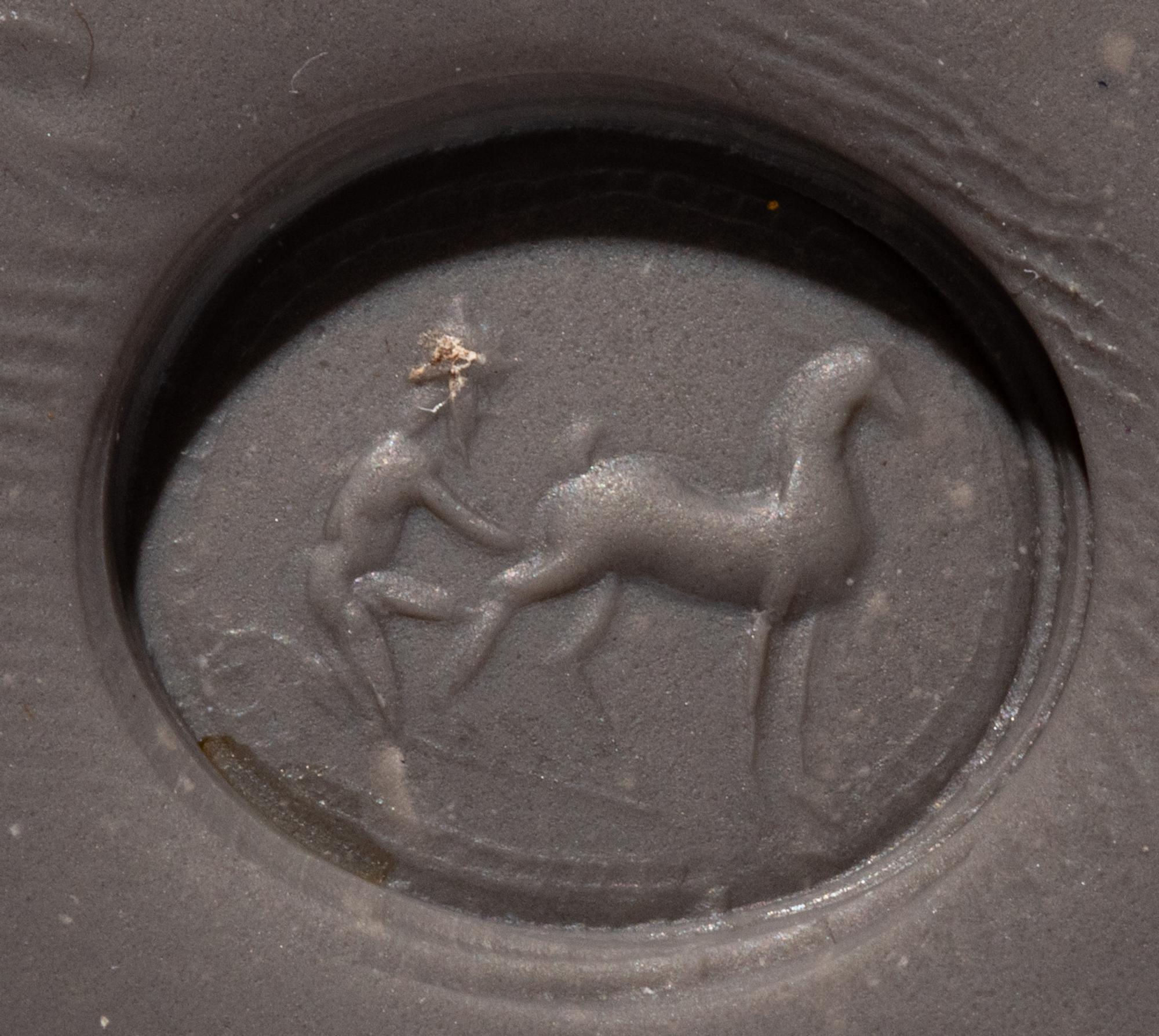 A Roman Carnelian Ring Stone with a Goatherder Milking a Goat