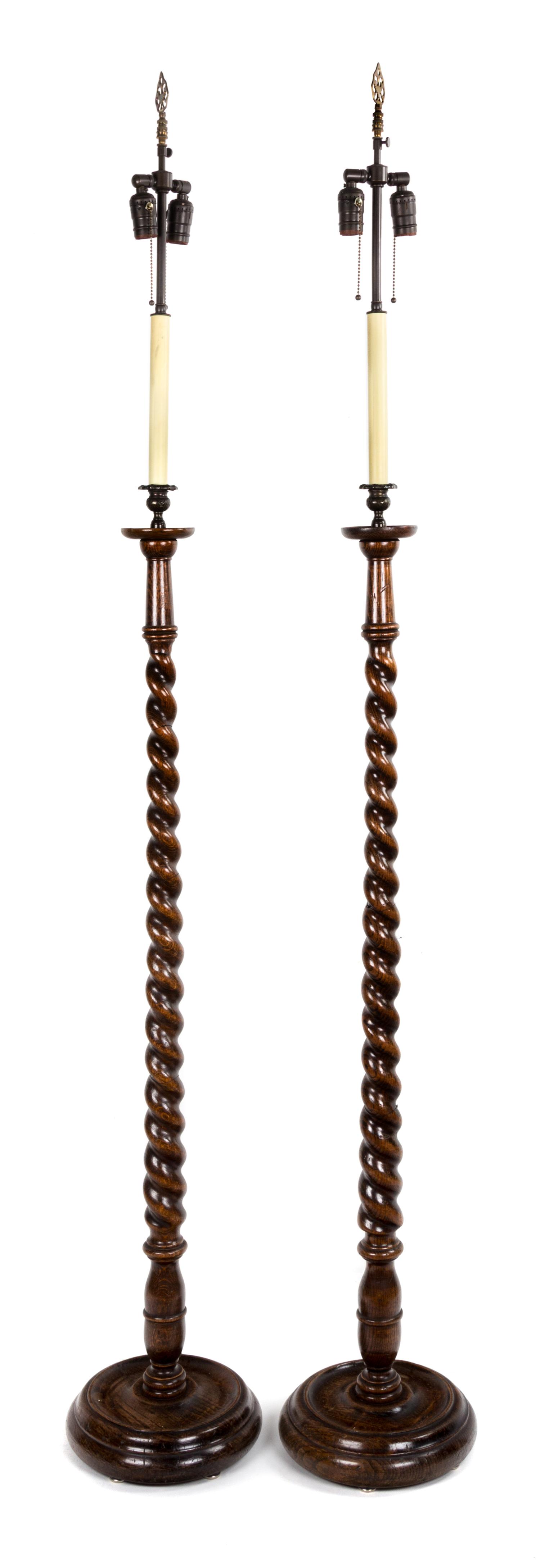 A Pair of Georgian Style Oak Standing Lamps Height 54 inches.