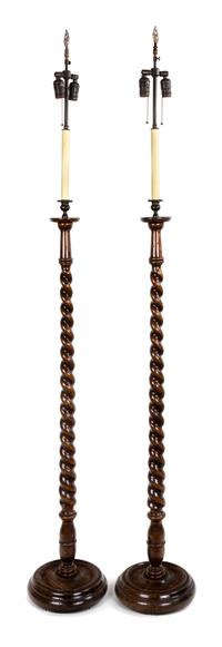 A Pair of Georgian Style Oak Standing Lamps Height 54 inches.