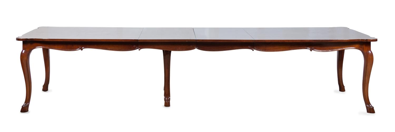 A Louis XV Provincial Style Mahogany Banquet Table the rectangular top with shaped ends, resting on cabriole legs terminating in hoof f