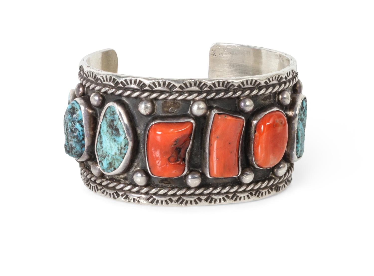 A Navajo Coral and Silver Bracelet, Jerry Roan Length 5 1/2 x opening 1 x width 1 1/4 inches.