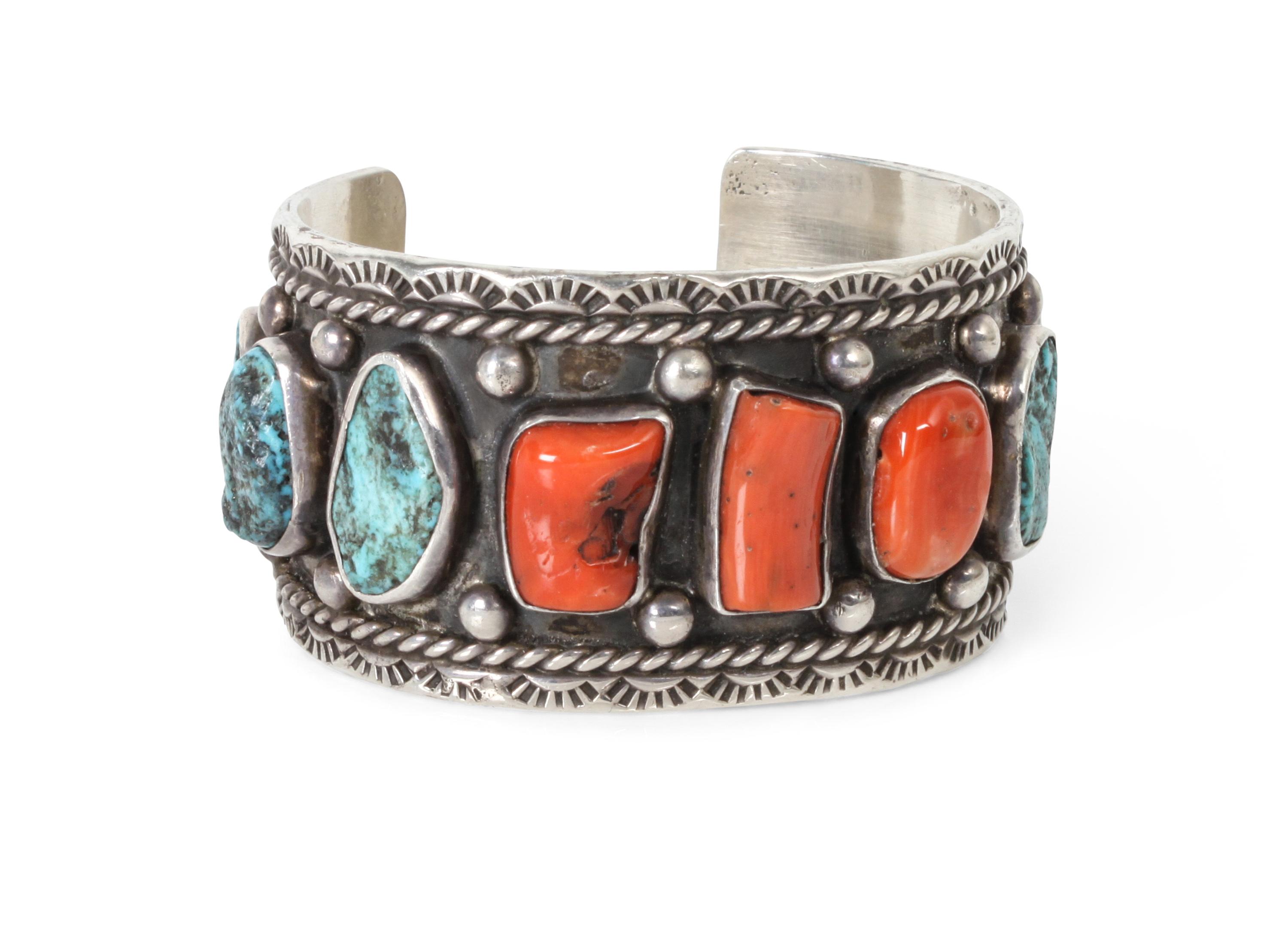 A Navajo Coral and Silver Bracelet, Jerry Roan Length 5 1/2 x opening 1 x width 1 1/4 inches.