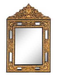 A Régence Style Gilt Pressed Metal and Ebonized Ripple-Molded Mirror