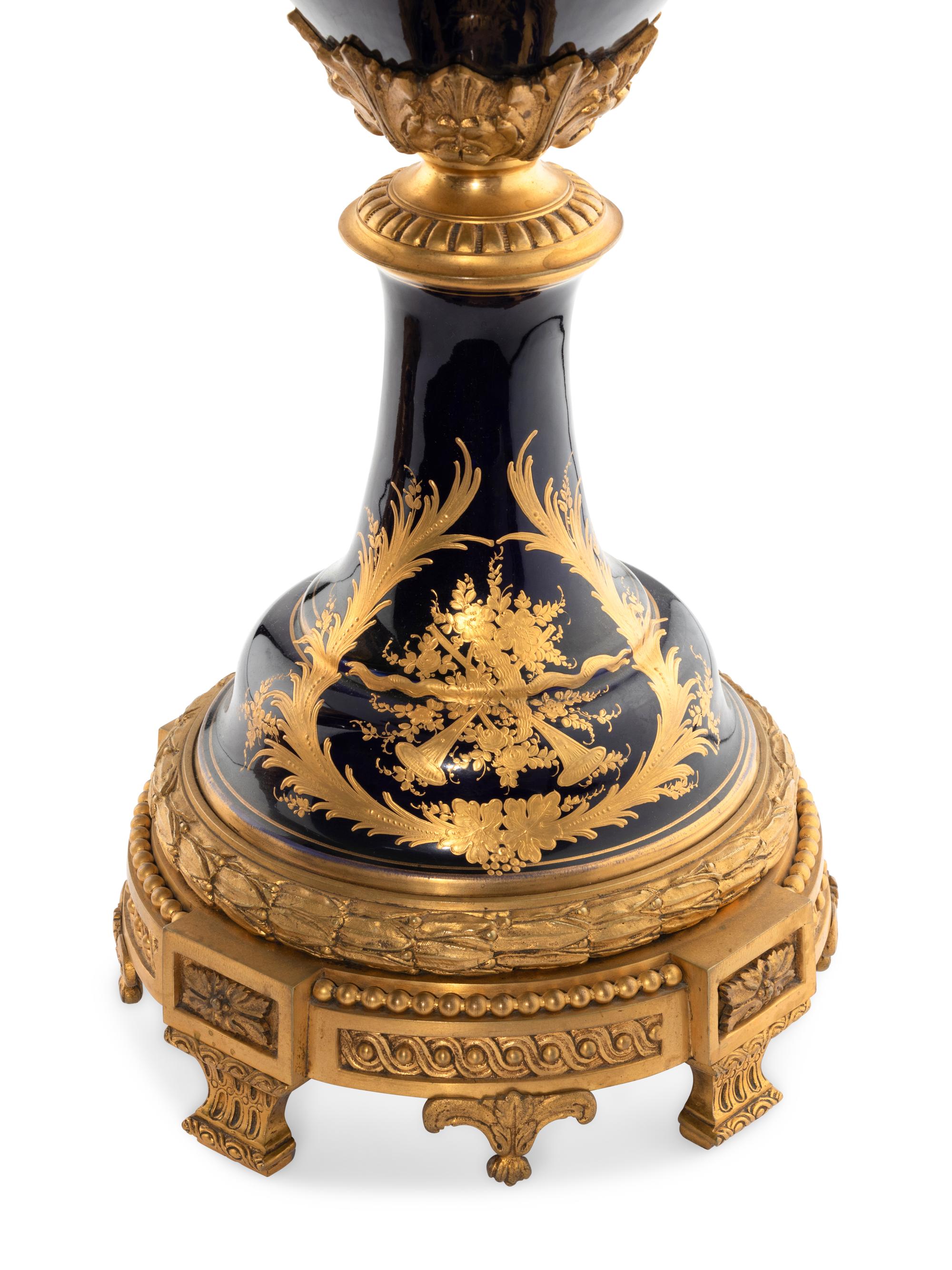 A Pair of Gilt Bronze Mounted Sèvres Style Porcelain Urns