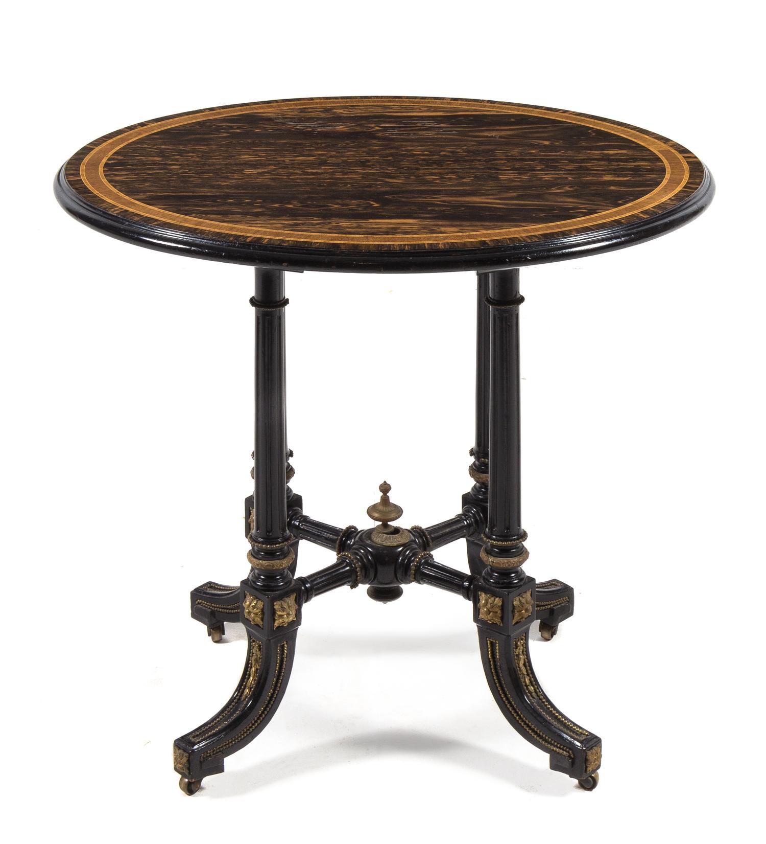 A Victorian Calamander and Ebony Occasional Table LATE 19TH CENTURY having an oval top with a mo... — LATE 19TH CENTURY