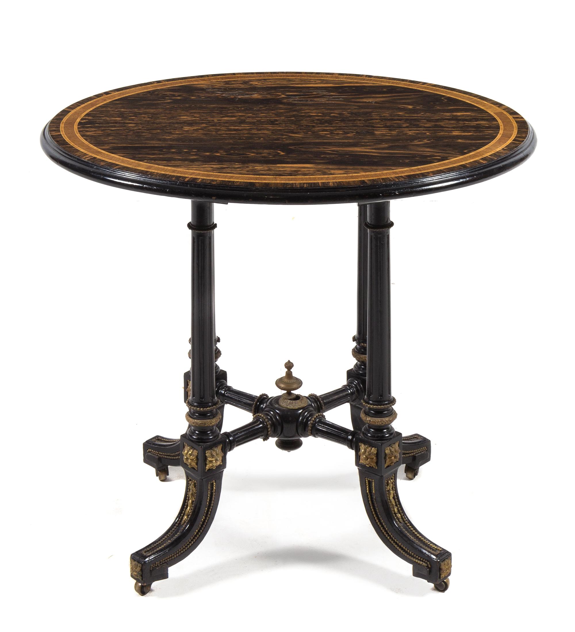 A Victorian Calamander and Ebony Occasional Table LATE 19TH CENTURY having an oval top with a mo... — LATE 19TH CENTURY