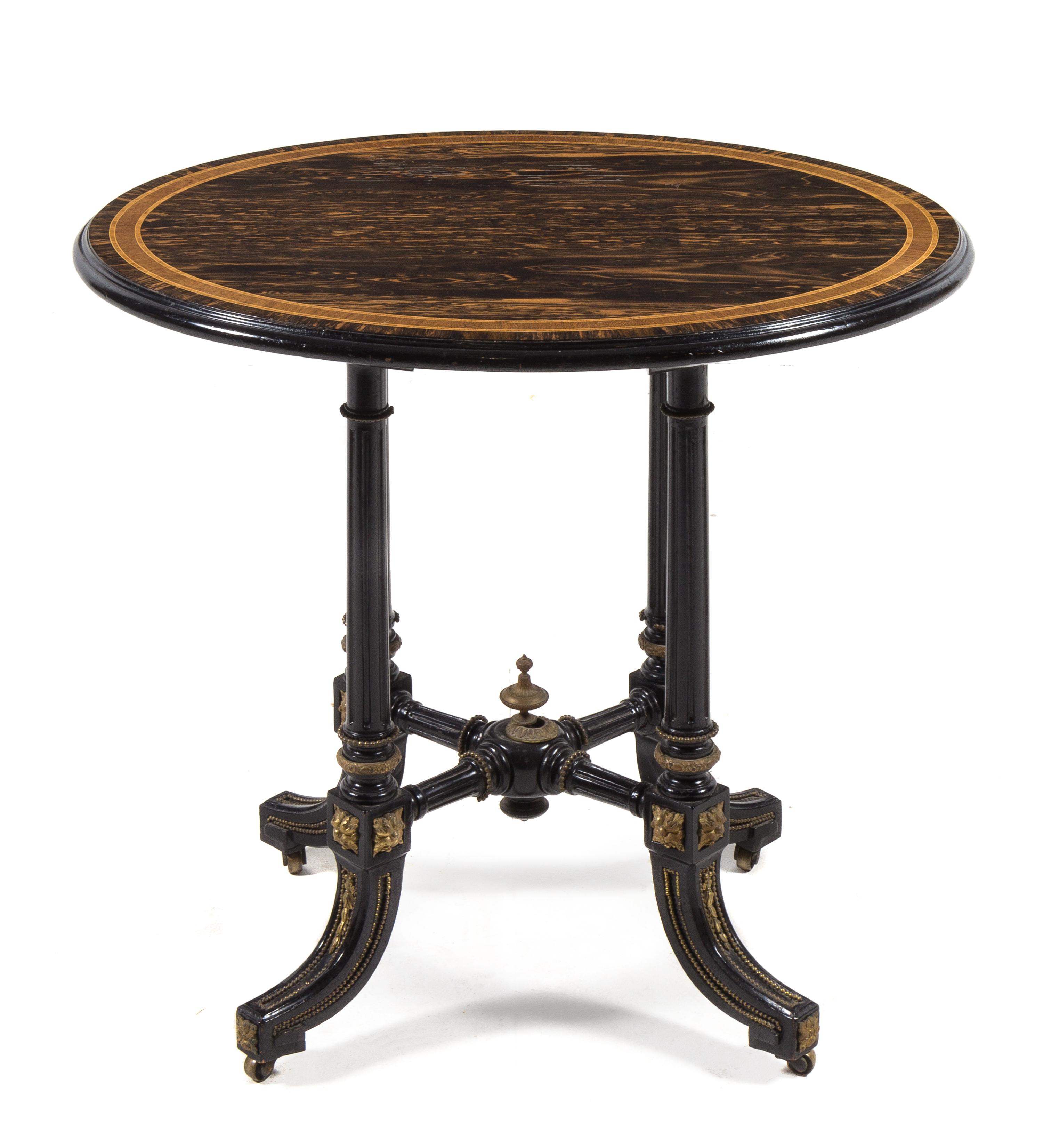 A Victorian Calamander and Ebony Occasional Table LATE 19TH CENTURY having an oval top with a mo... — LATE 19TH CENTURY