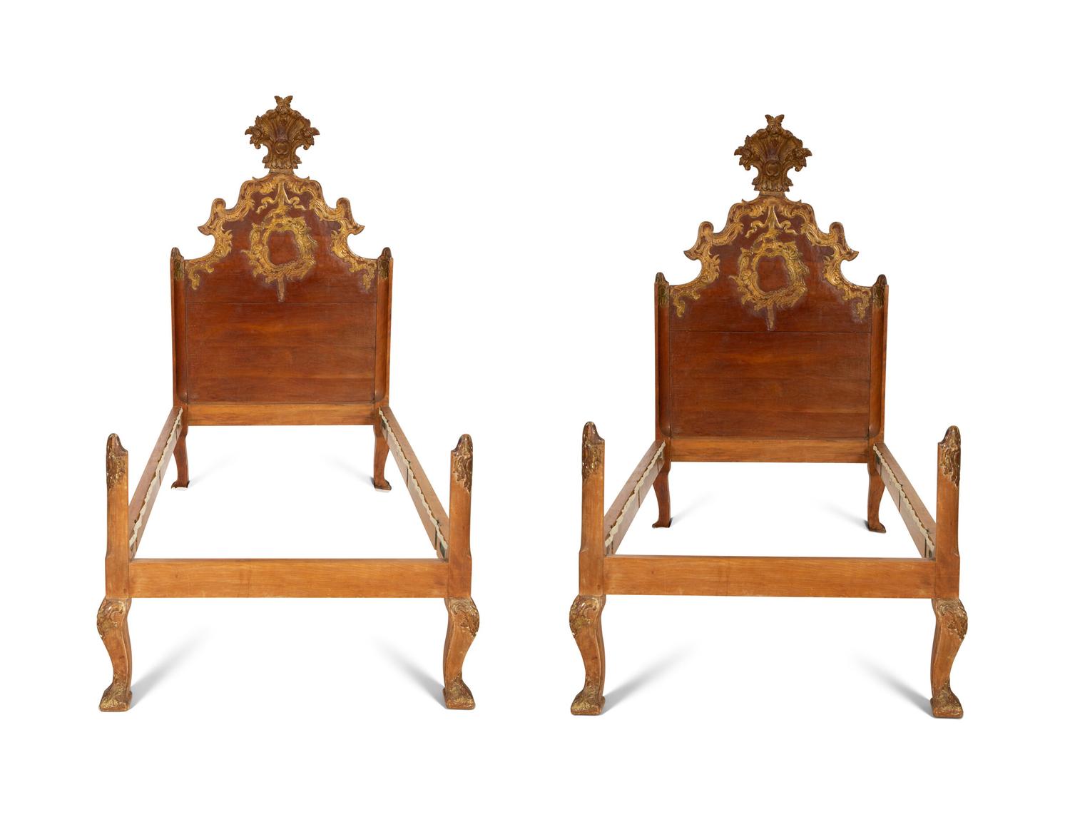 A Pair of Venetian Style Fruitwood and Parcel Gilt Twin Beds