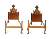 A Pair of Venetian Style Fruitwood and Parcel Gilt Twin Beds
