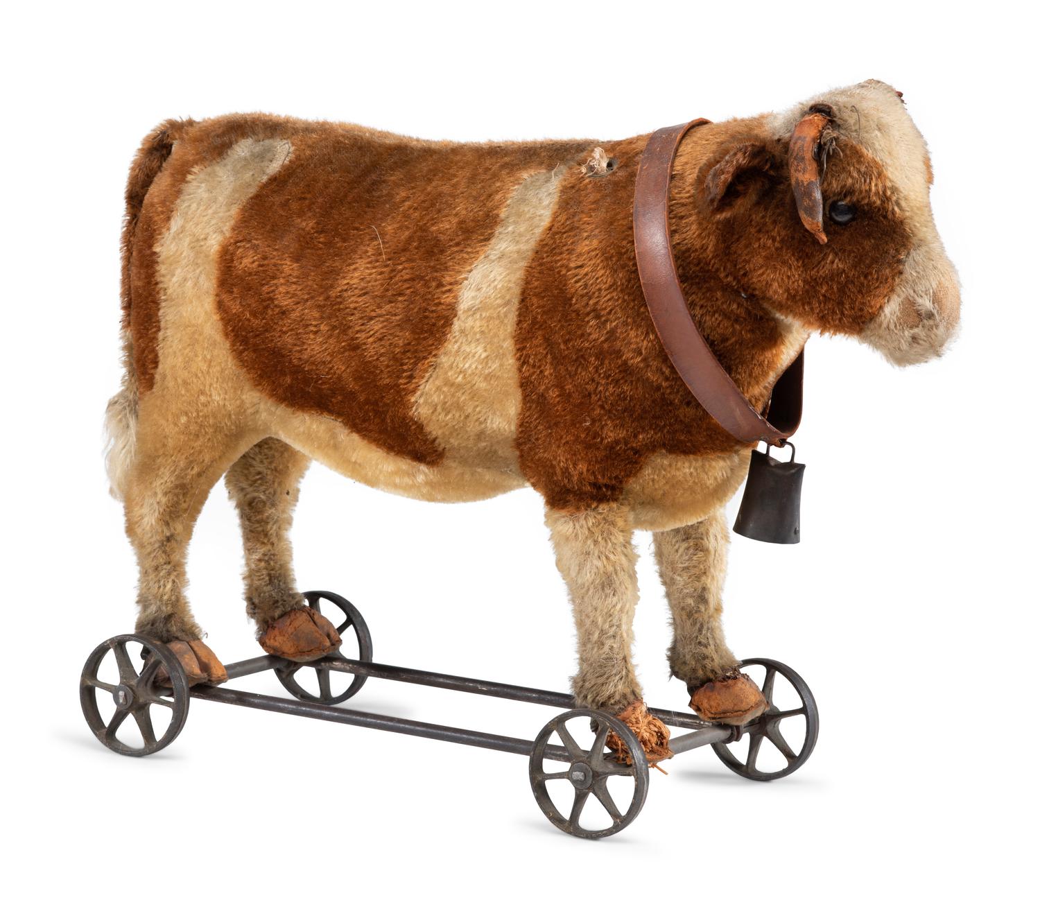An Upholstered Leather Cow-Form Pull Toy