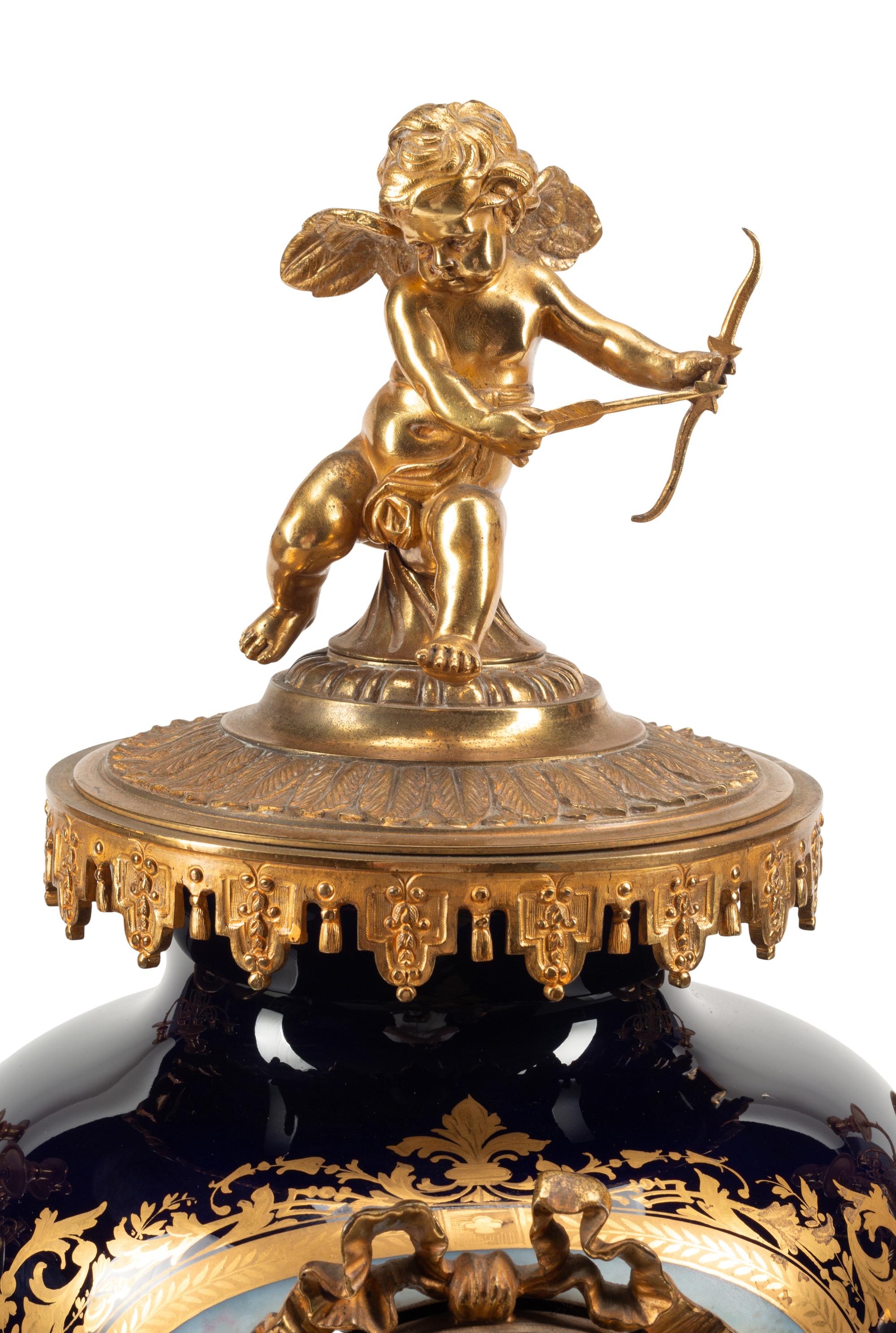 A Louis XVI Style Gilt Bronze and Sèvres Style Porcelain Clock Garniture