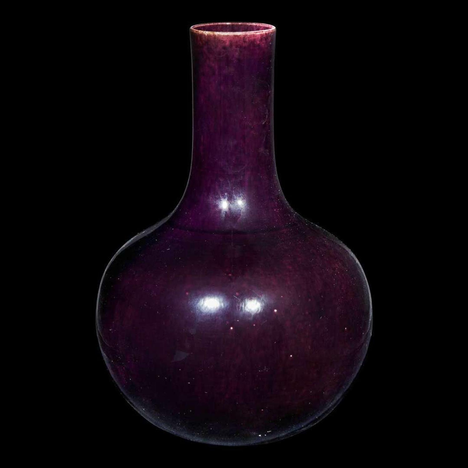 A Chinese aubergine-glazed porcelain bottle vase, Tianqiuping 茄皮紫天球瓶一只