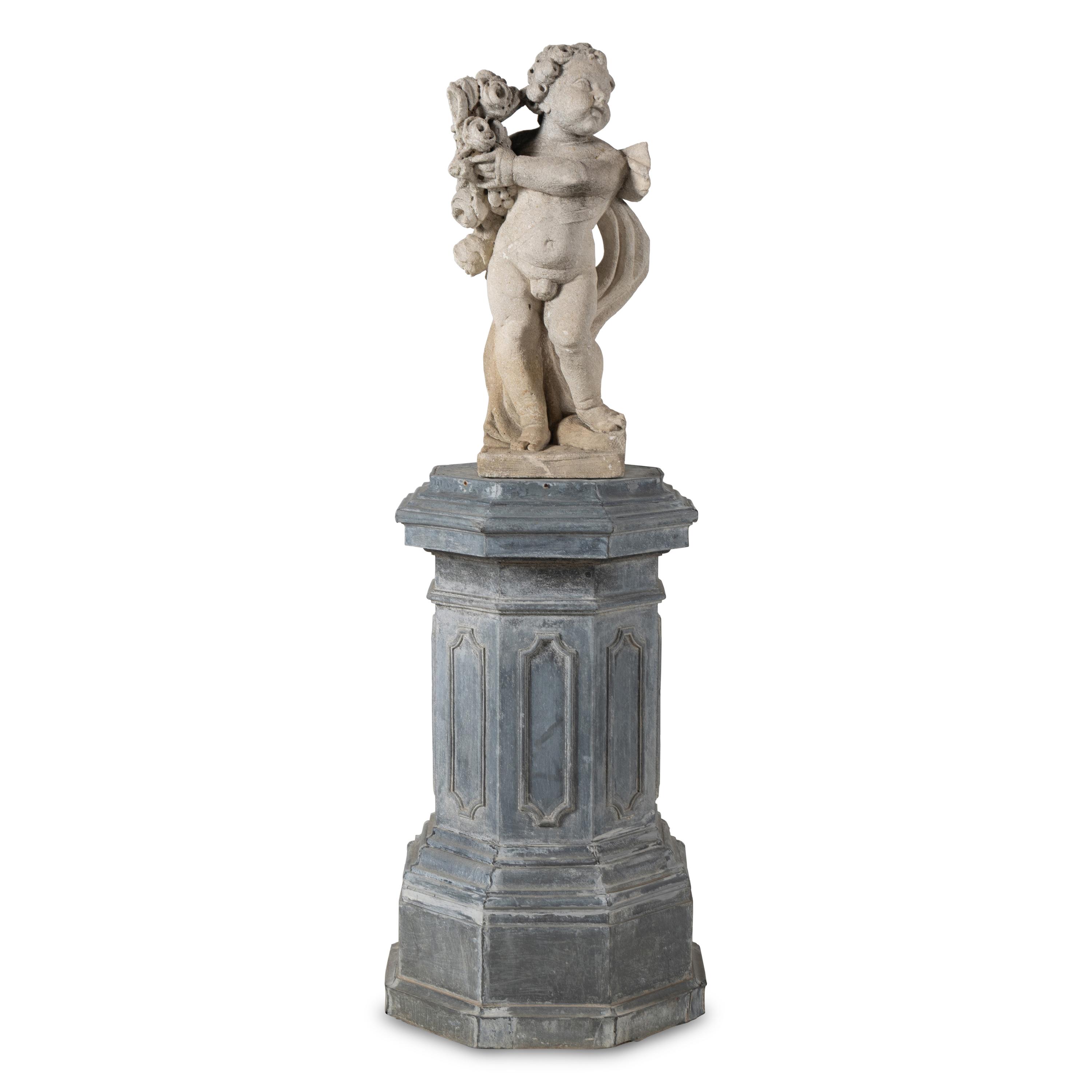 A Cast Stone Garden Figure of a Putto on a Zinc Pedestal