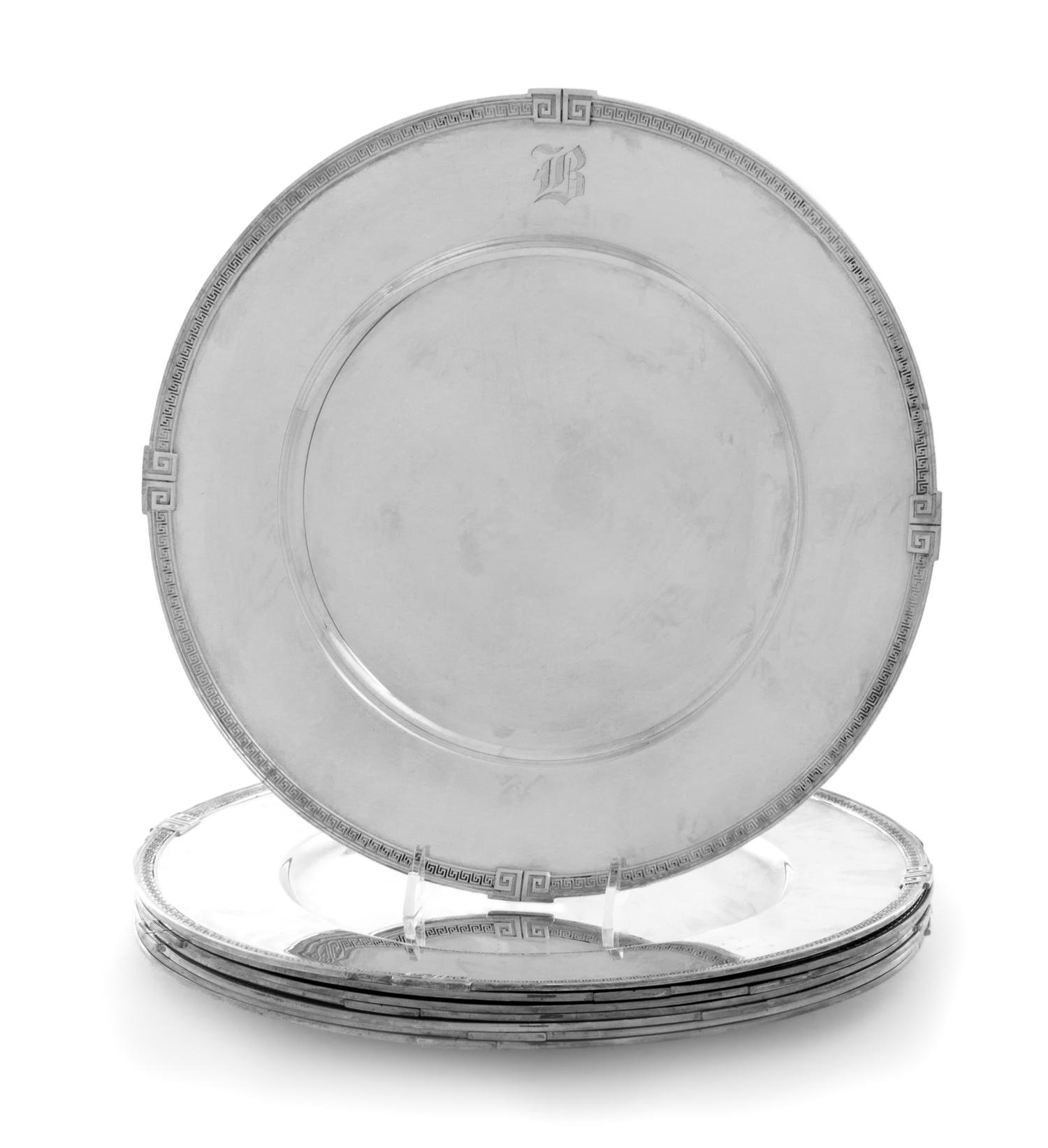 A Set of Seven American Silver Dinner Plates, Gorham Mfg. Co., Providence, RI, each having a Greek key decorated border.