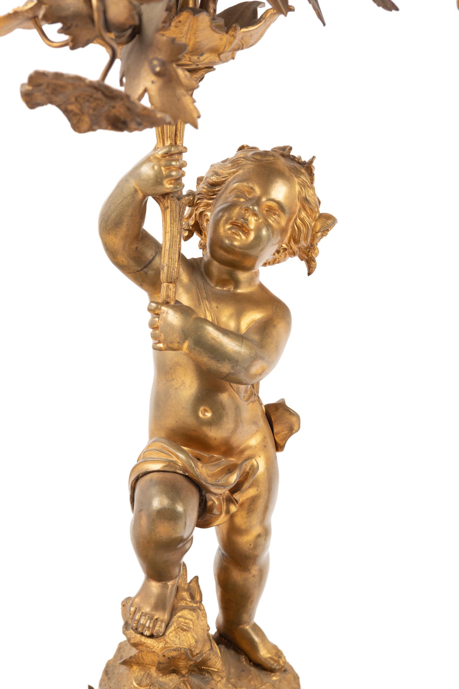 A Pair of French Gilt Bronze and Marble Figural Eight-Light Candelabra