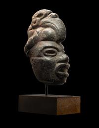 A Maya Stone Hacha of a Warrior Wearing a Helmet in the Form of a Macaw