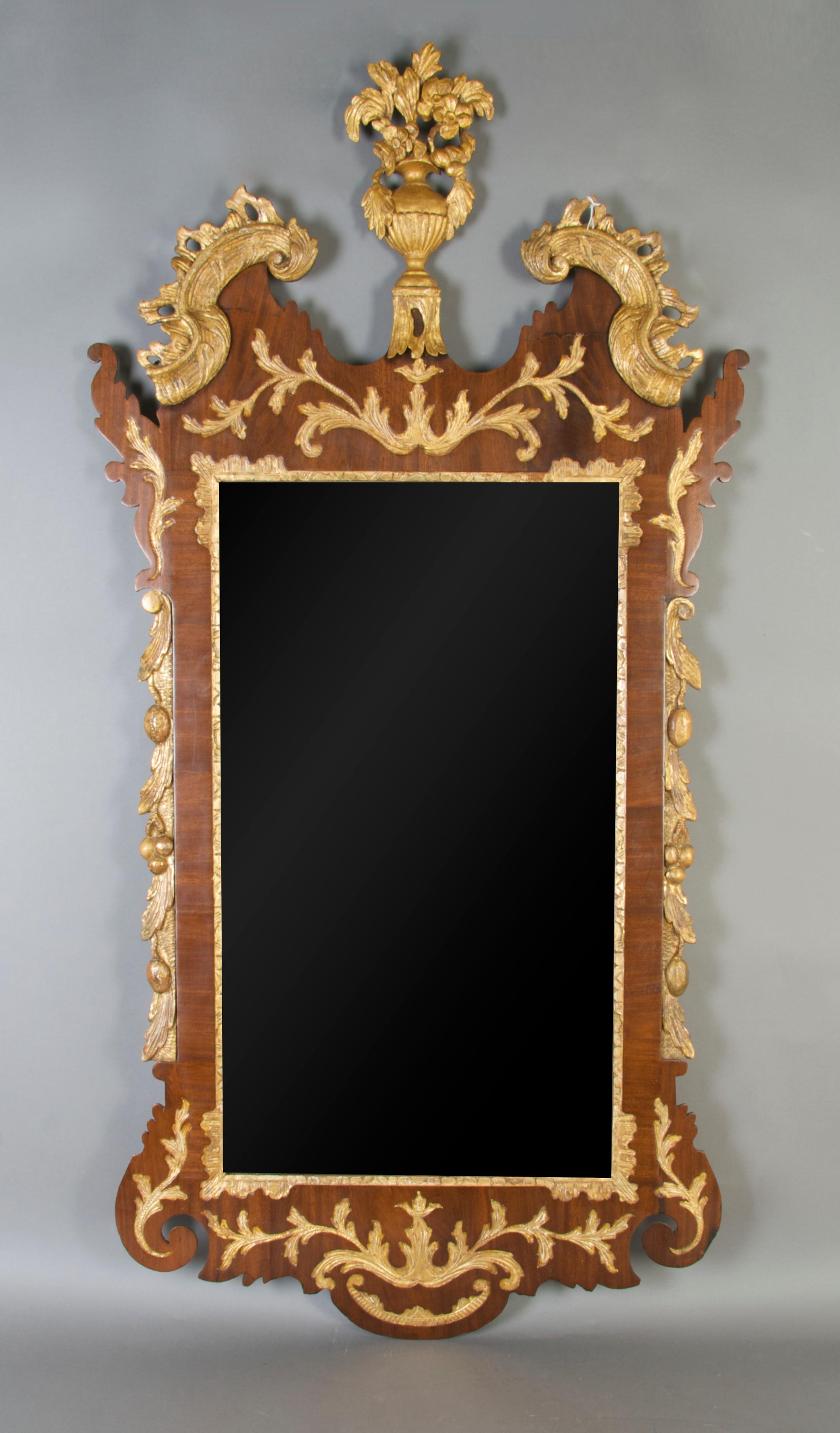 A George III Mahogany Parcel Gilt Mirror, Height 51 1/2 x width 26 inches.