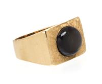 A 14 Karat Yellow Gold and Black Star Sapphire Ring, 12.20 dwts.