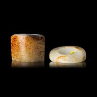 Two Chinese Russet and White Jade Archer's Rings, Qing Dynasty 清 白玉留皮扳指兩枚