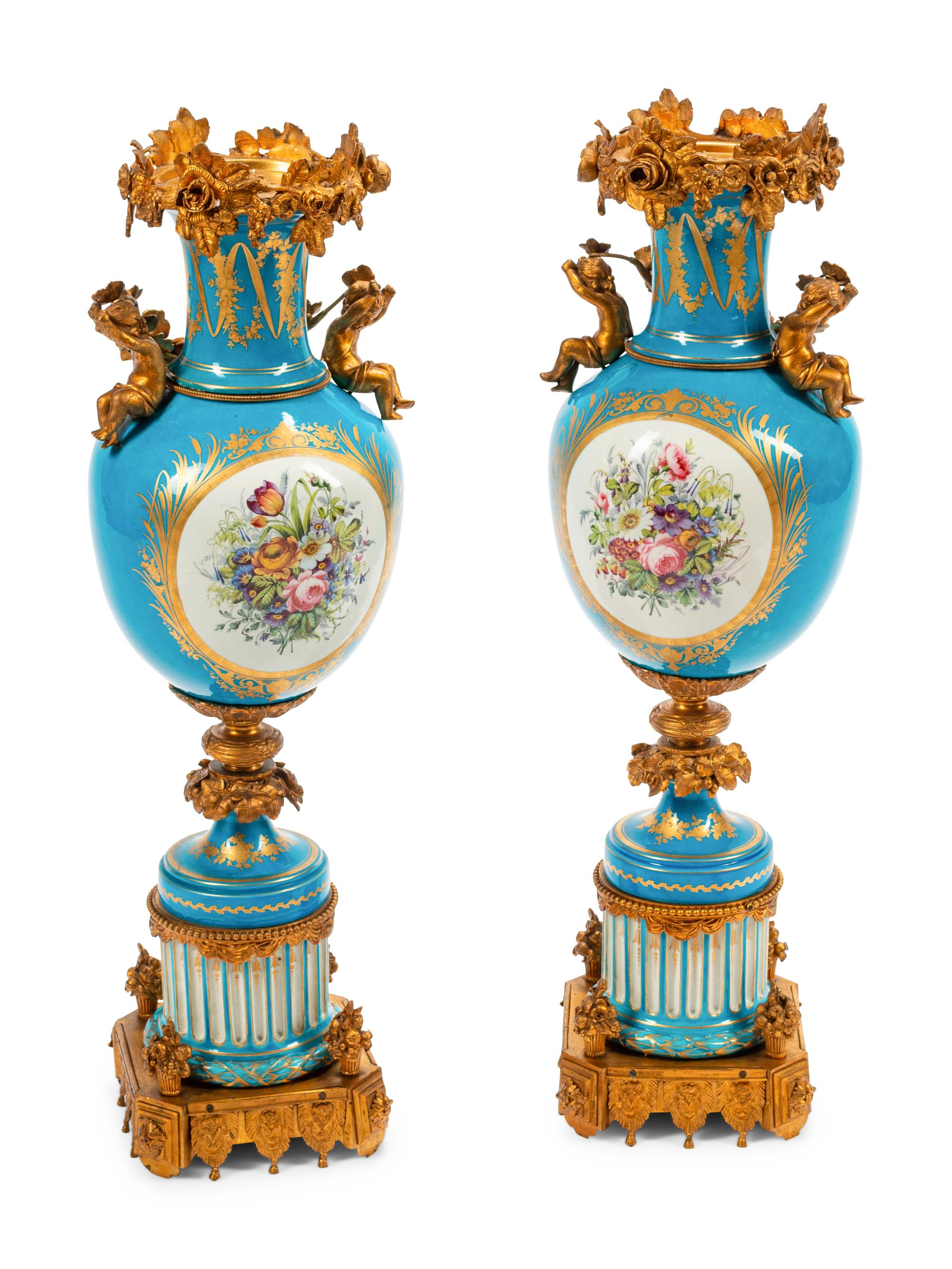 A Pair of Sèvres Style Gilt Bronze Mounted Porcelain Urns
