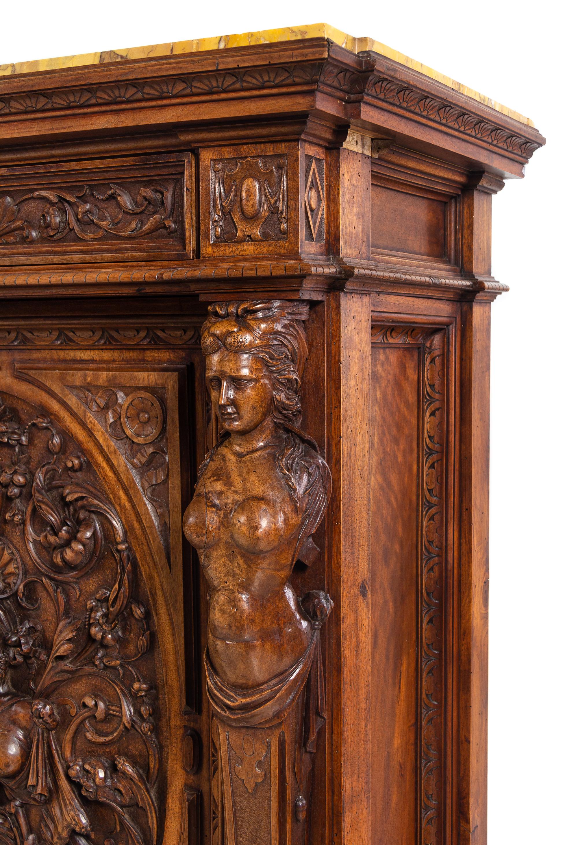 A Pair of Renaissance Revival Carved Walnut Marble-Top Cabinets