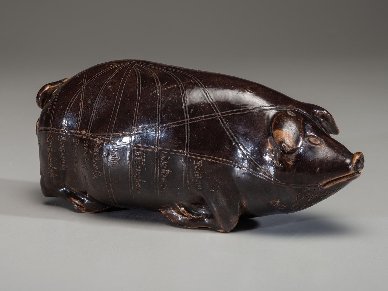 An Anna Pottery Incised and Brown Glazed Pig Flask