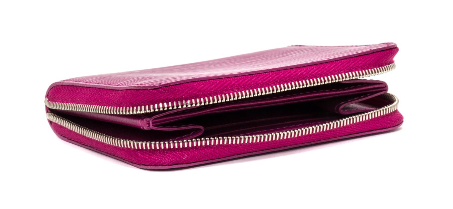 A Louis Vuitton Fuschia Epi Zippy Coin Purse, 4.3"x 3.3" x 0.8".