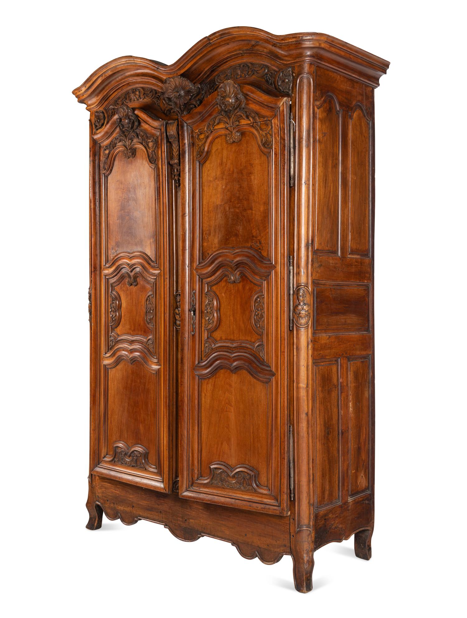 A Louis XV Carved Walnut Armoire