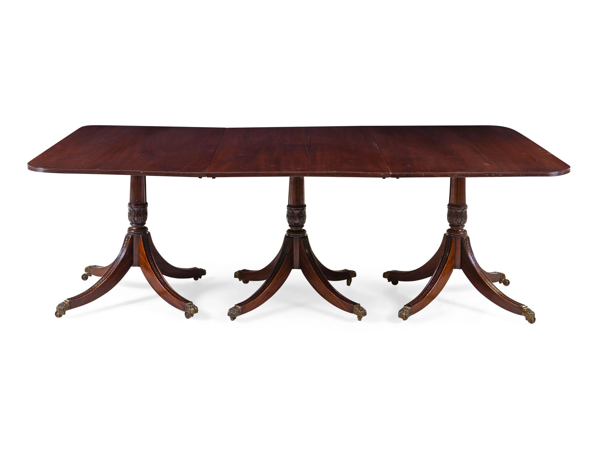 A Regency Style Mahogany Triple-Pedestal Extension Dining Table