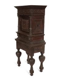 A Pair of Continental Carved Oak Cabinets on Stands