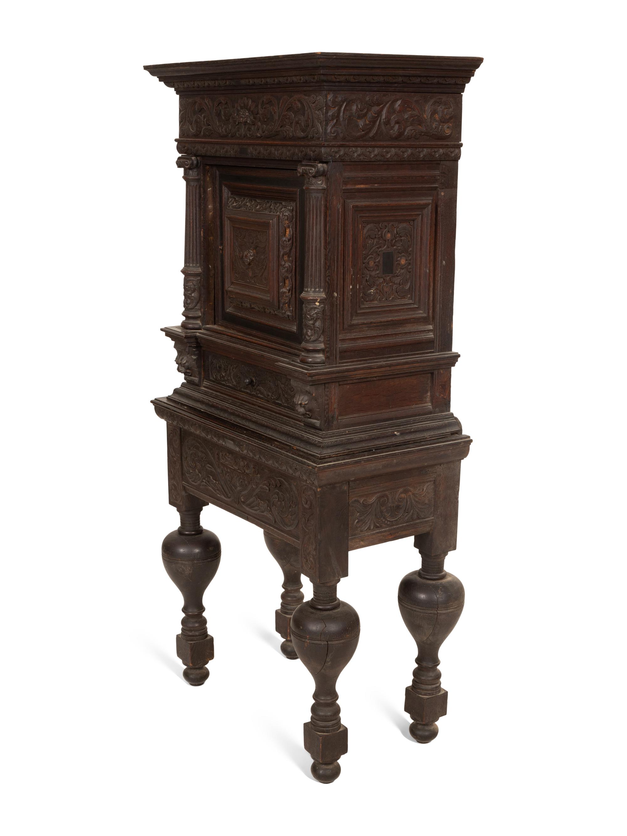A Pair of Continental Carved Oak Cabinets on Stands