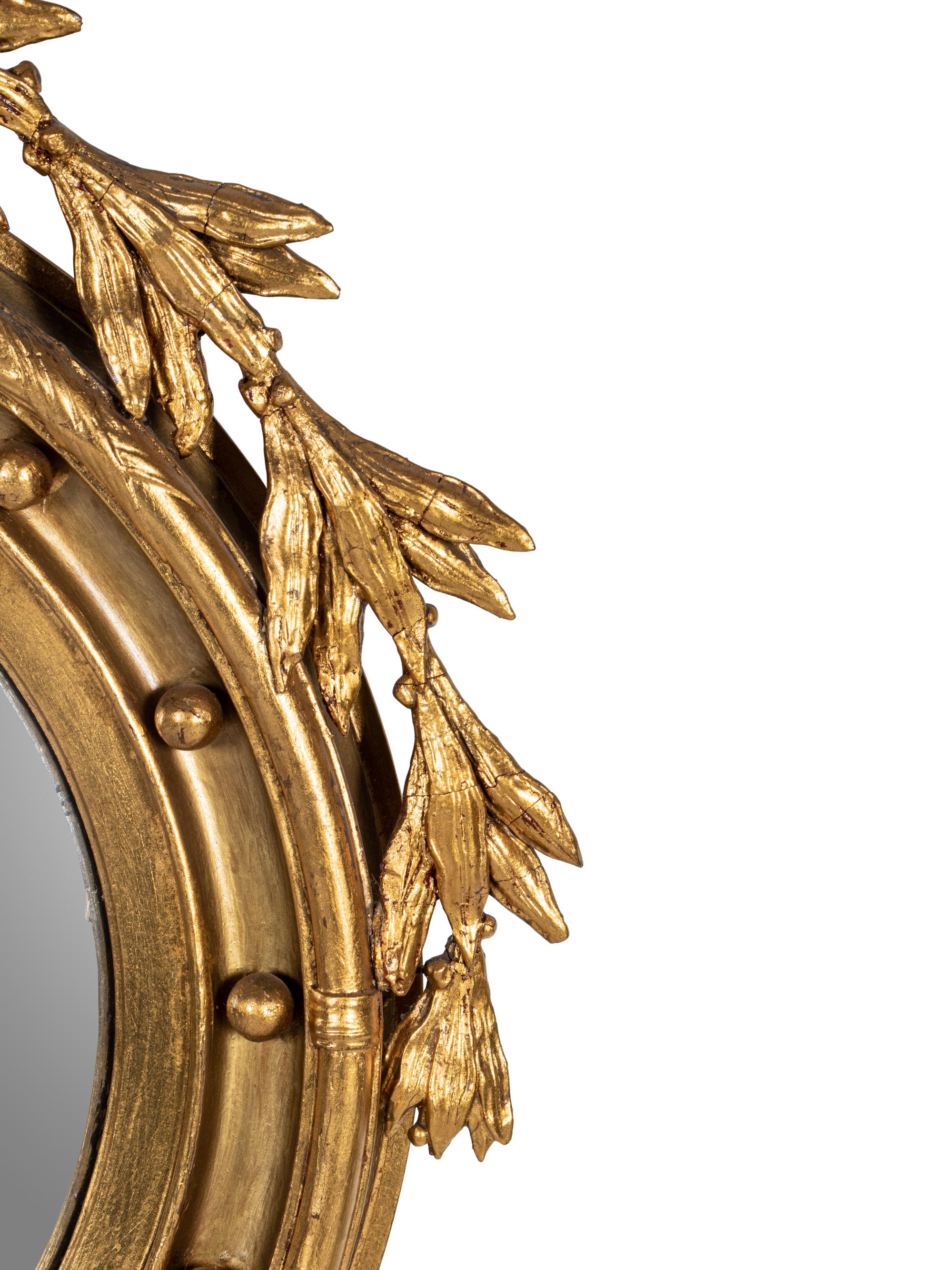 A Federal Style Eagle and Shell Giltwood Bull's Eye Mirror