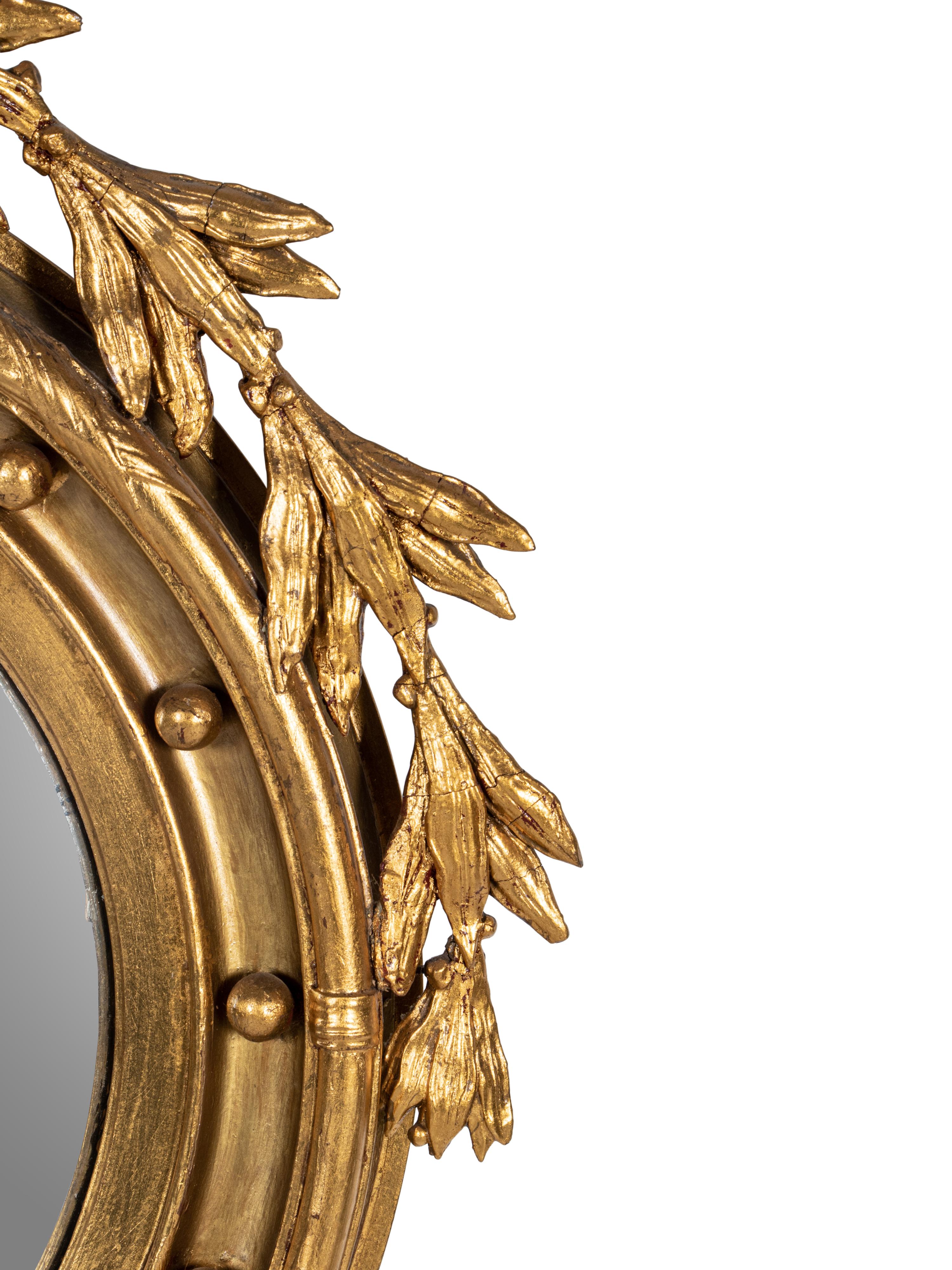 A Federal Style Eagle and Shell Giltwood Bull's Eye Mirror