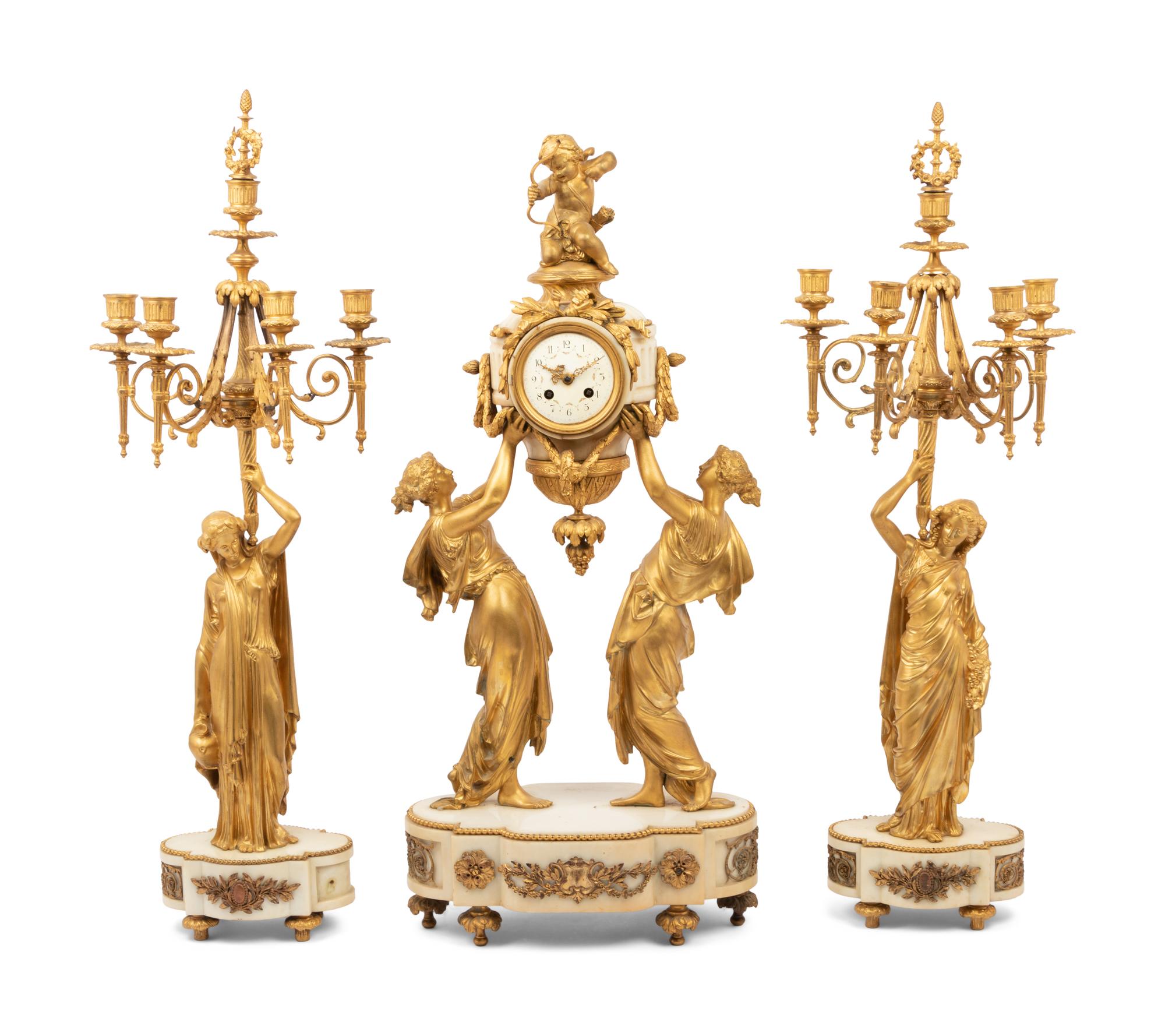 A Louis XVI Style Gilt Bronze and Marble Figural Clock Garniture