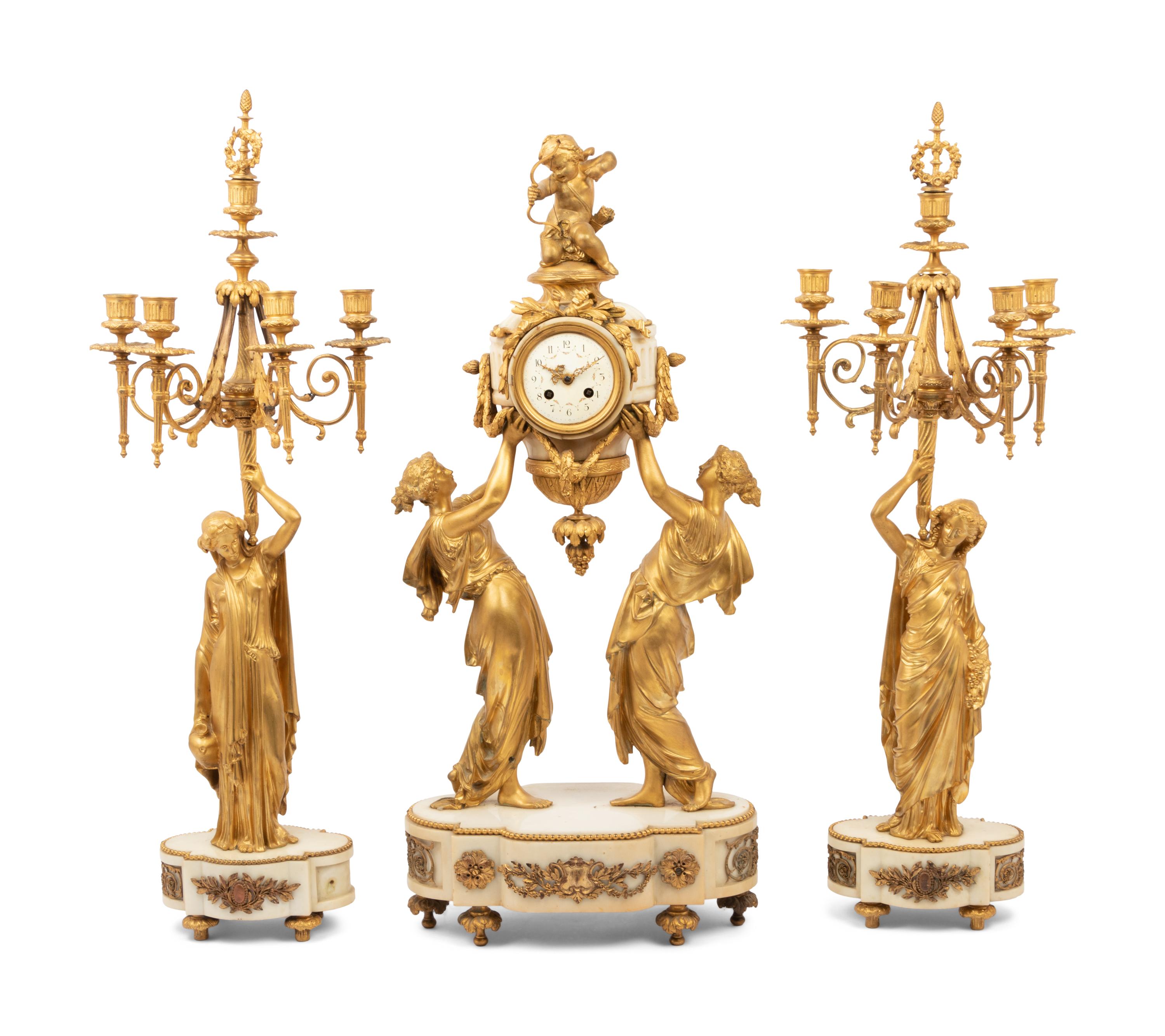 A Louis XVI Style Gilt Bronze and Marble Figural Clock Garniture