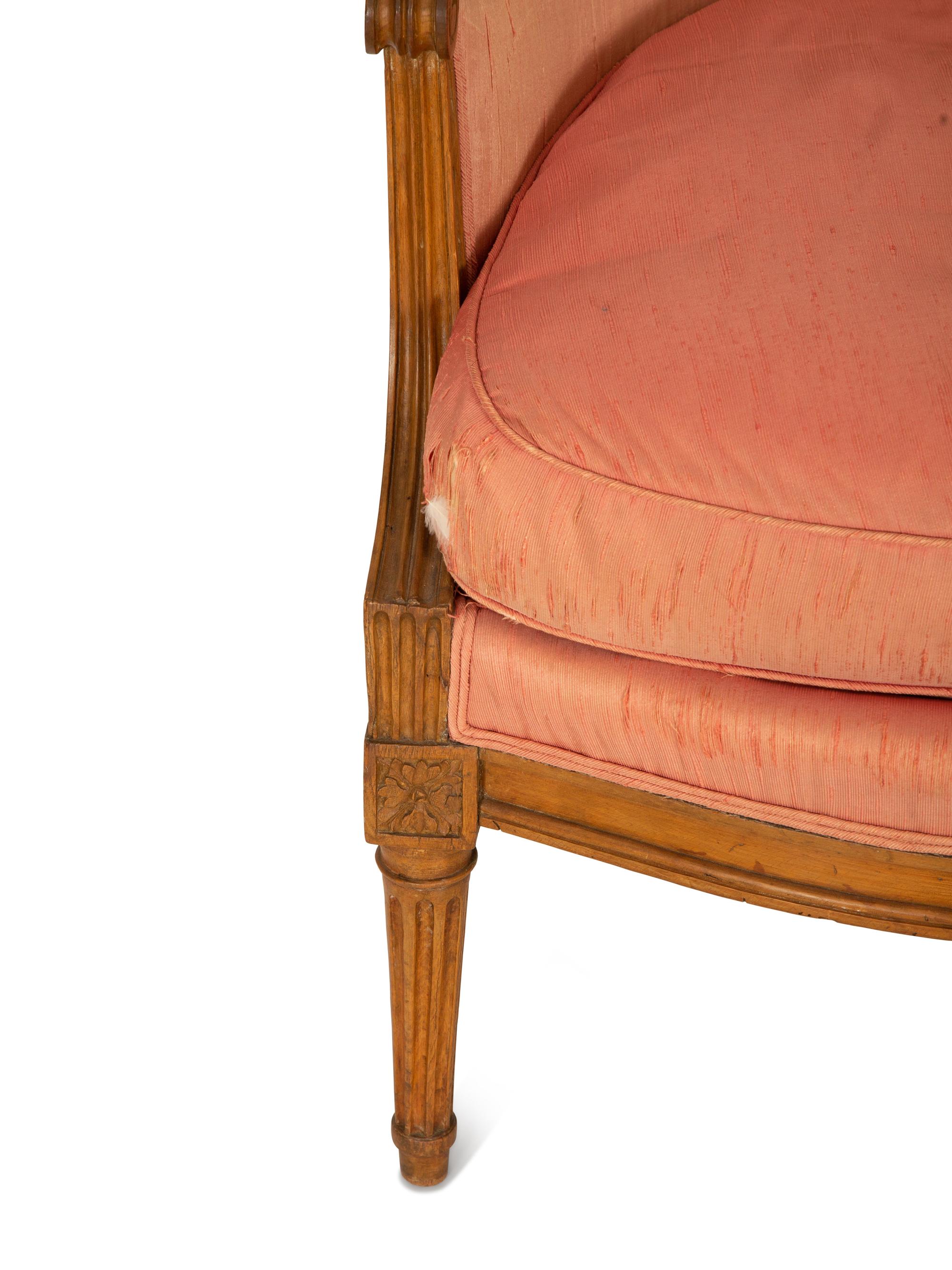 A Louis XVI Carved Walnut Bergère