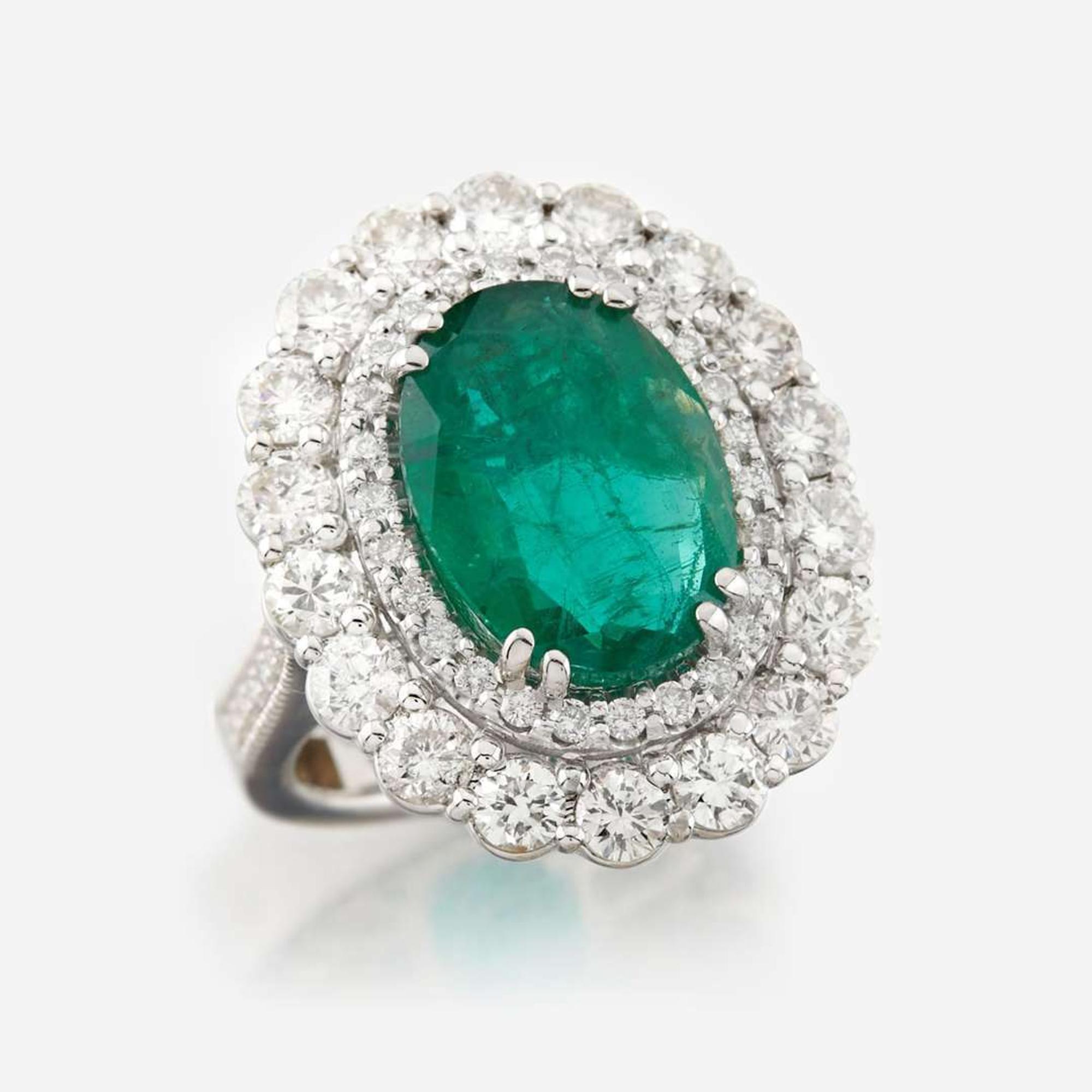 An emerald, diamond, and white gold ring