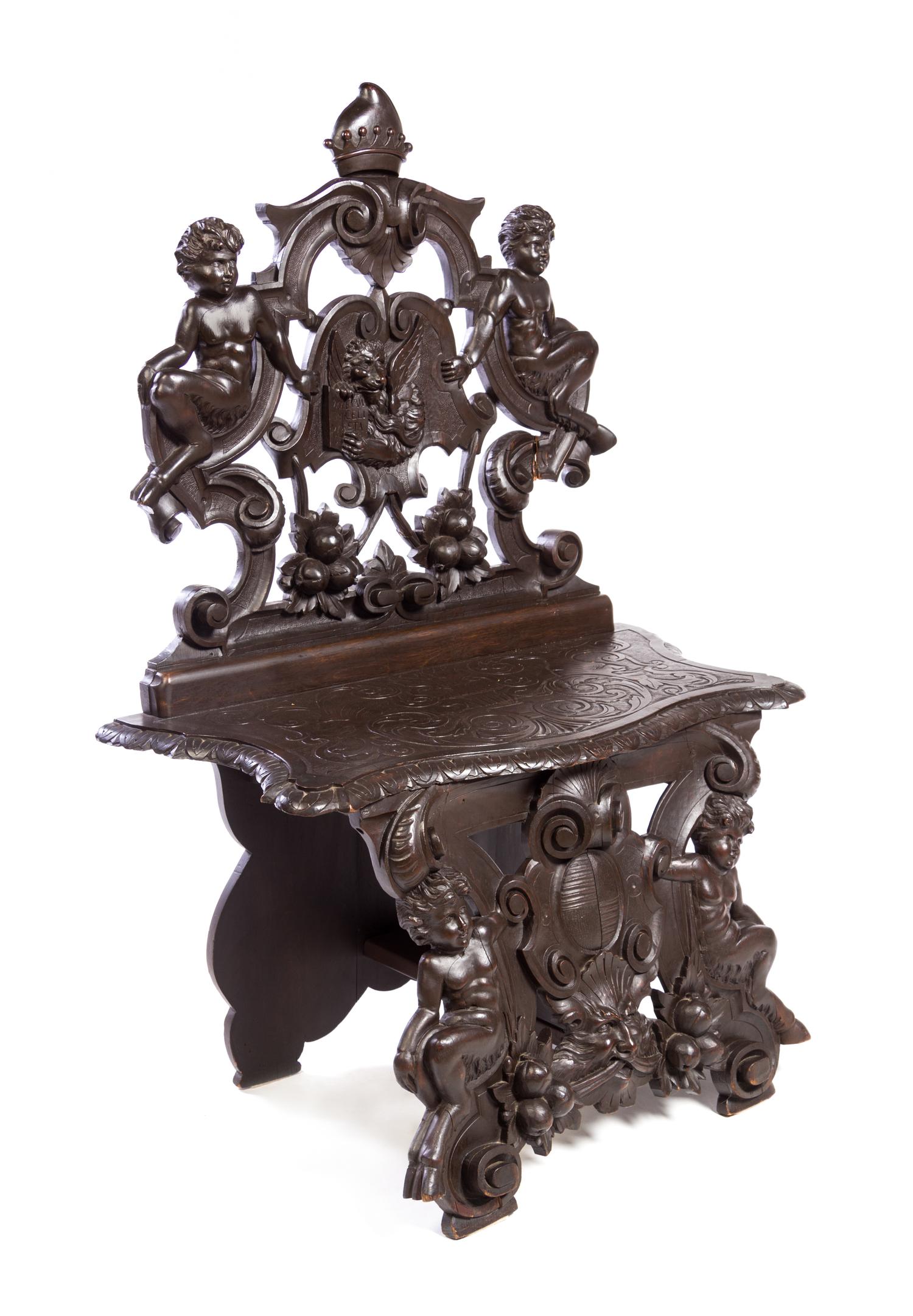 A Renaissance Style Carved Walnut Hall Chair Height 51 x width 34 1/2 inches. — 20TH CENTURY