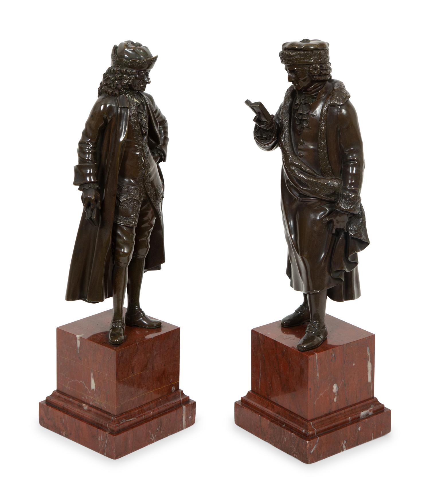A Pair of Bronze Sculptures of Voltaire and Rousseau