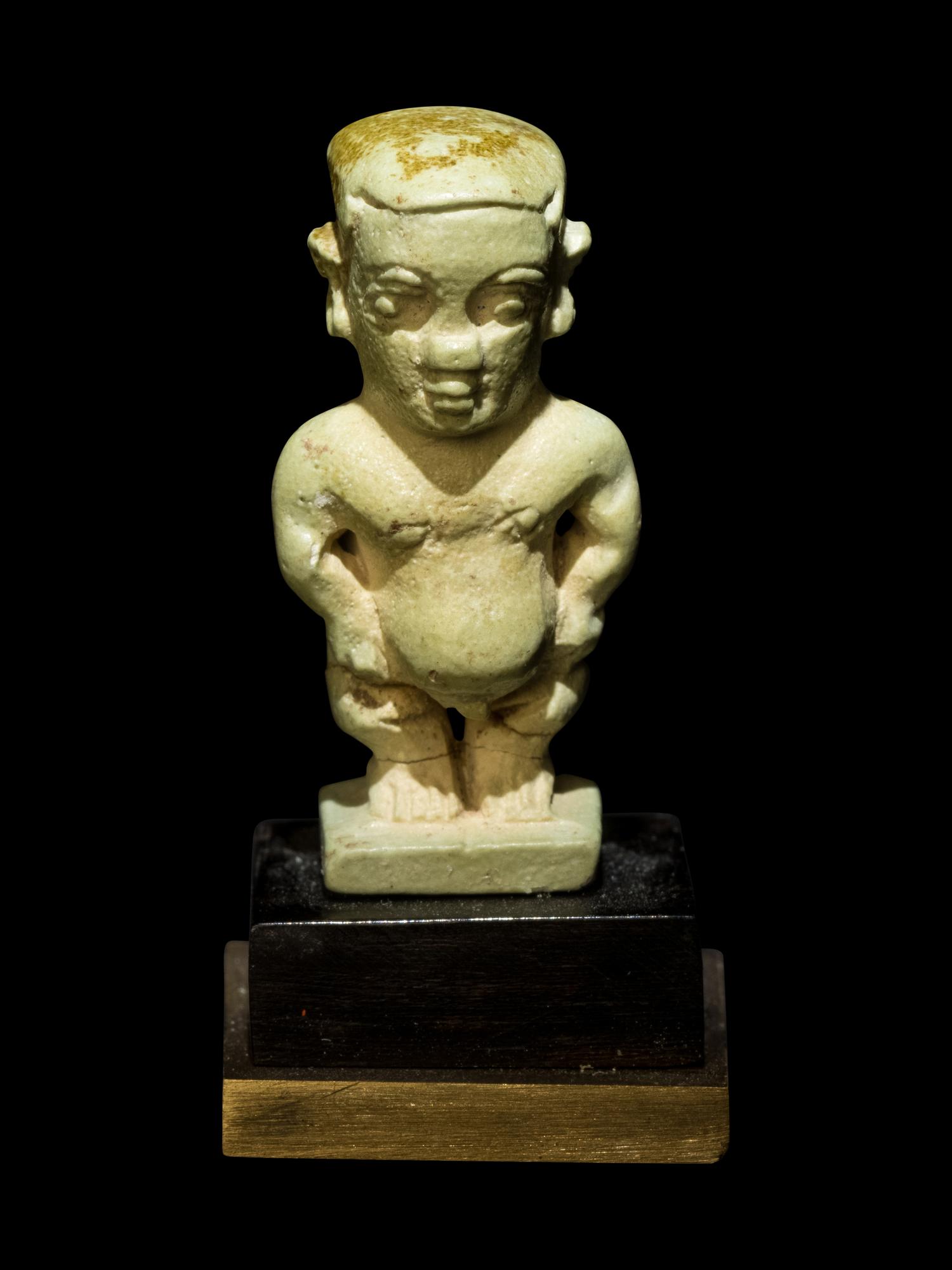 Three Egyptian Faience Amulets Including a Pataikos, a Harpocrates, and a Recumbent Lion