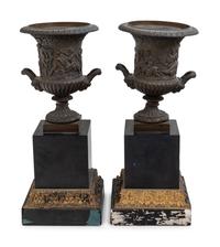 A Pair of Continental Bronze Urns with Associated Plinths