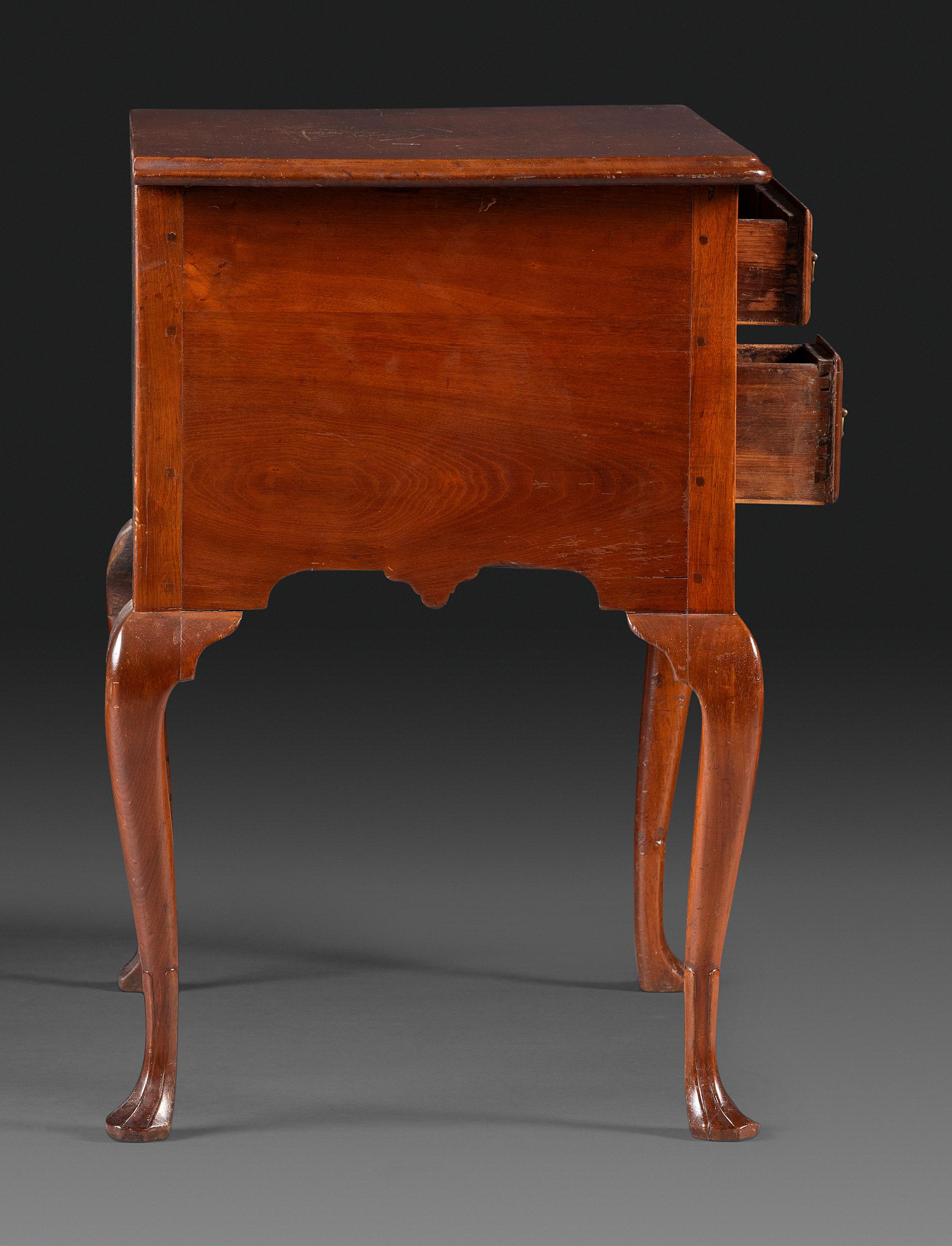 A Queen Anne Carved and Figured Walnut Dressing Table