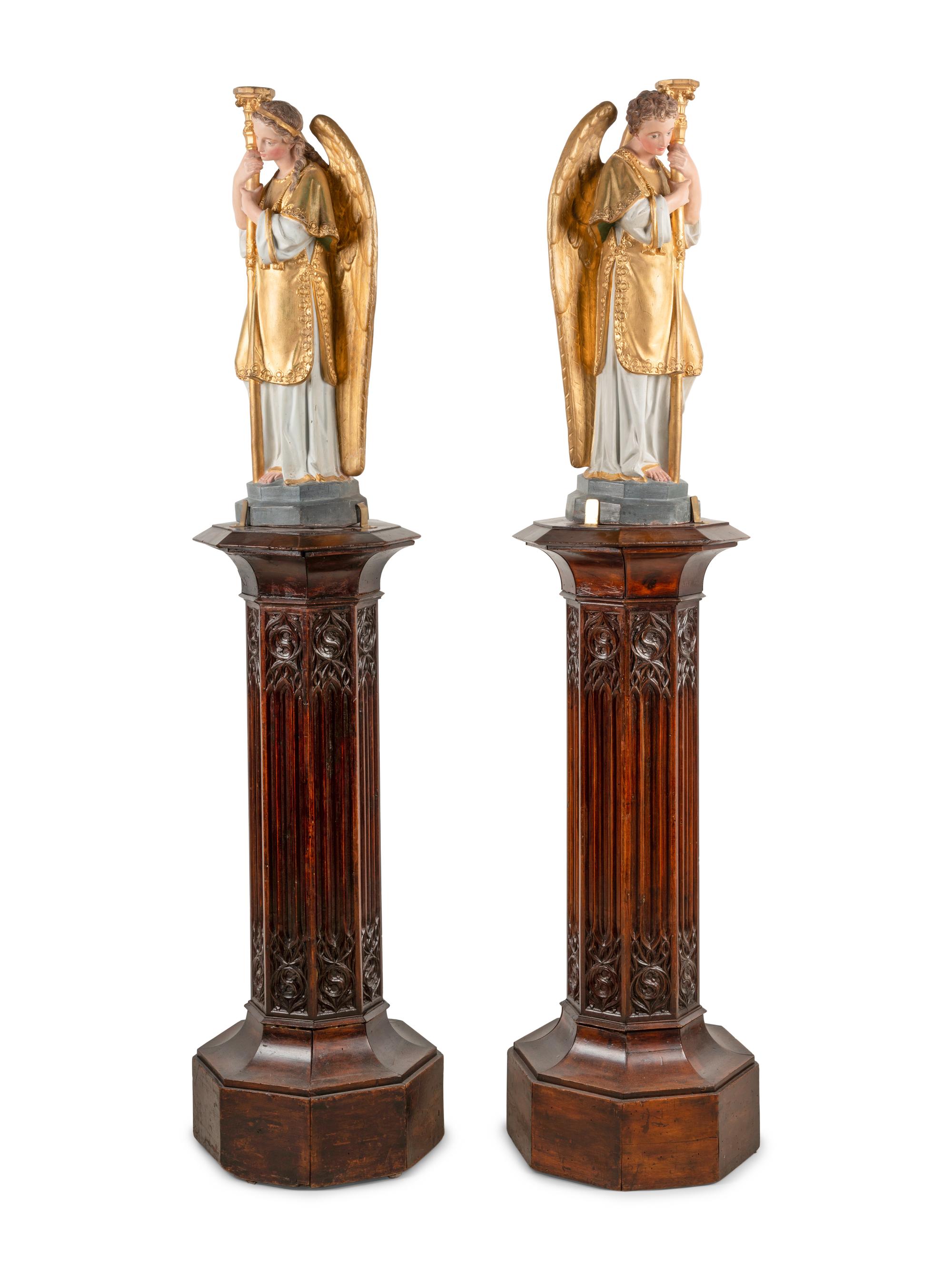 A Pair of Painted and Parcel Gilt Figural Altar Prickets with Associated Gothic Revival Pedestals