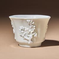A Chinese Blanc-de-Chine Porcelain Cup, 17th Century — 明末清初 德化白瓷貼塑梅紋花口杯