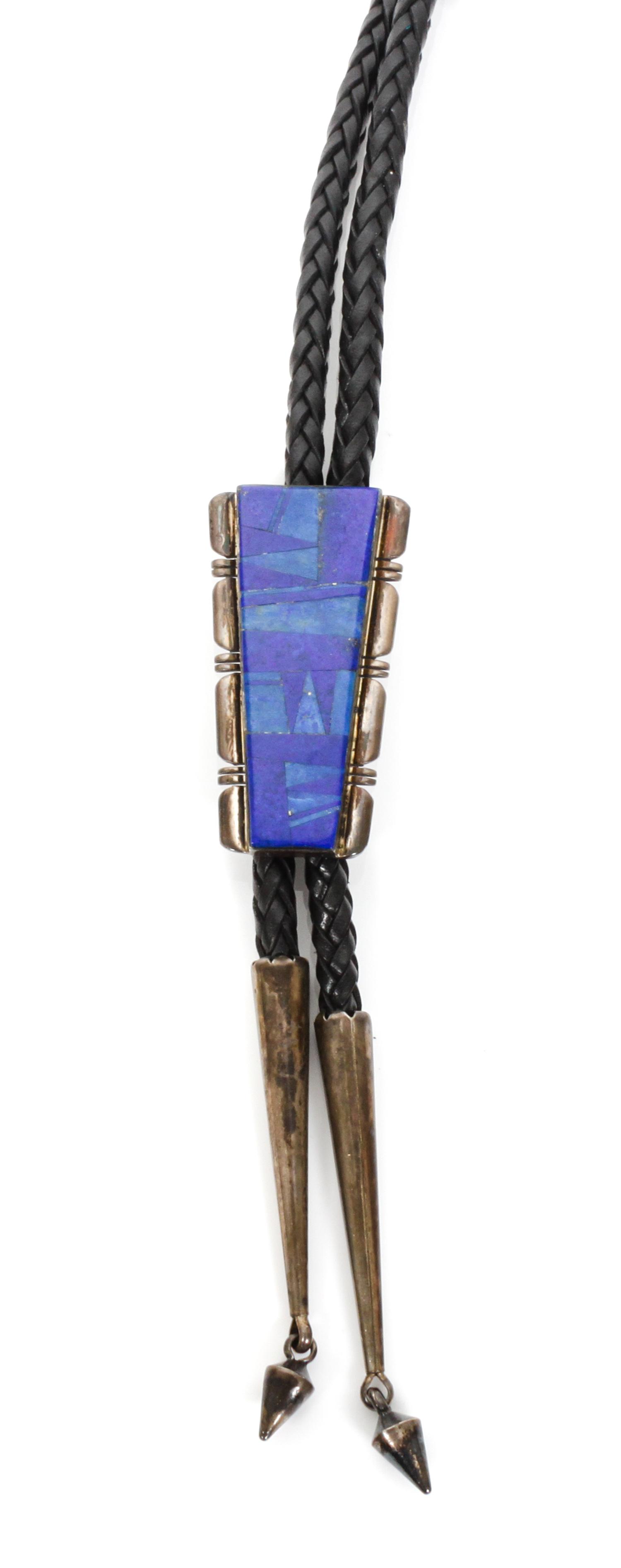 A Navajo Silver and Lapis Bolo, J. Charley Height 2 1/4 x 1 1/4 inches.
