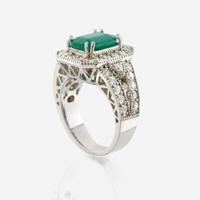 An emerald, diamond, and white gold ring