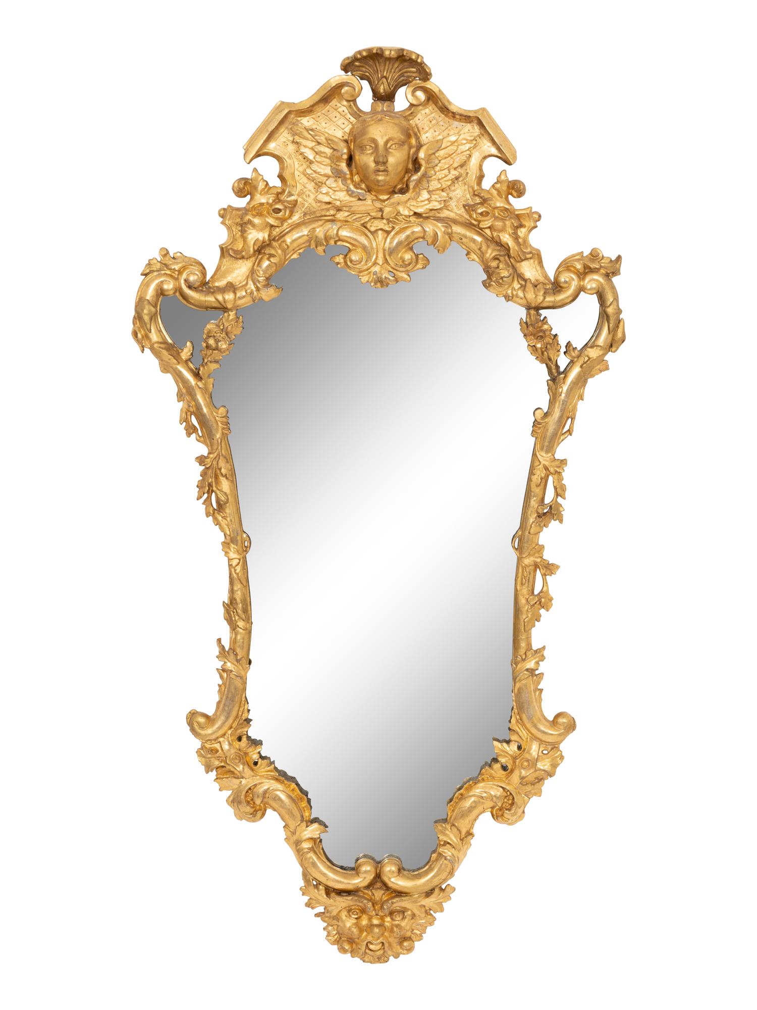 A Continental Baroque Cartouche-Form Giltwood Mirror