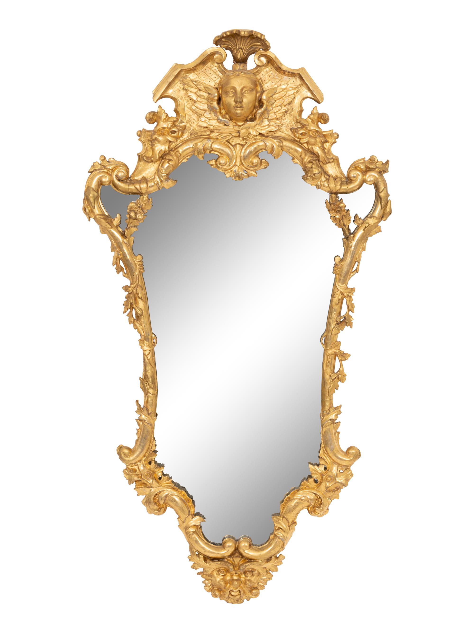 A Continental Baroque Cartouche-Form Giltwood Mirror